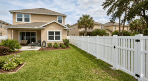 White vinyl privacy fence in a residential backyard