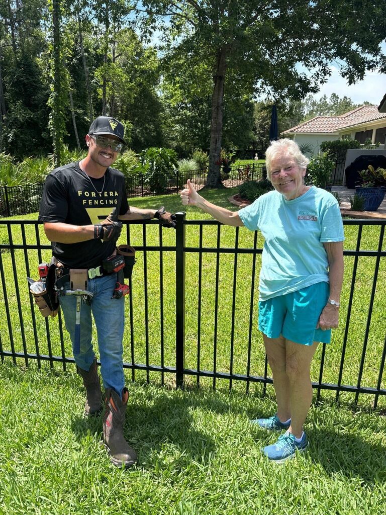 Aluminum Fence Installation with fortera fencing employee and happy customer